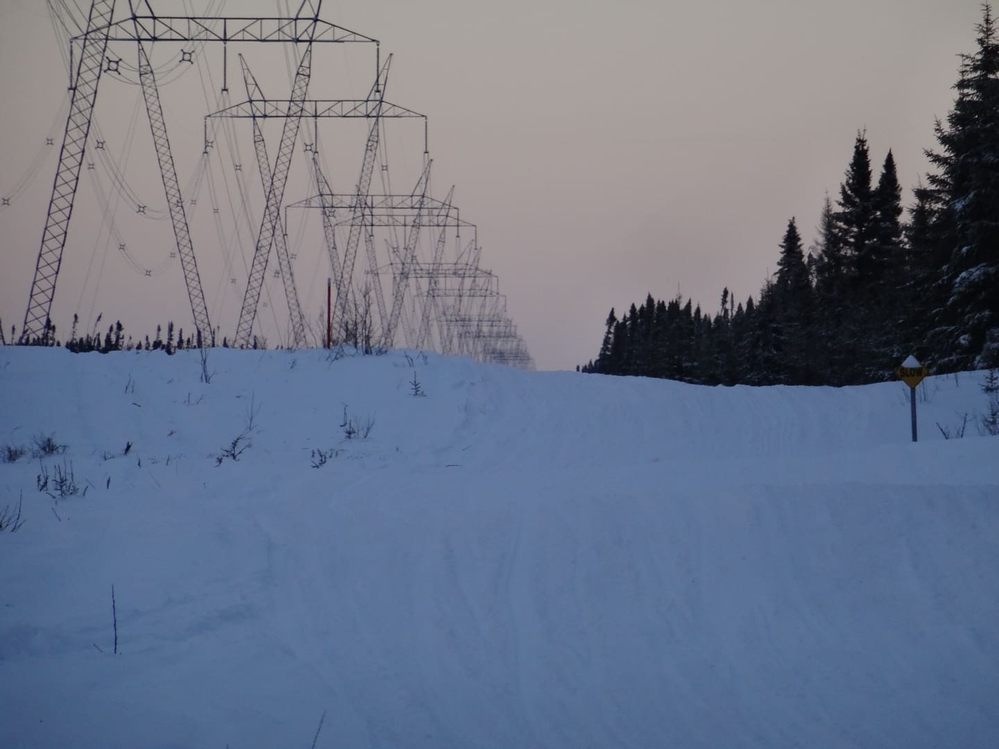 Hydro towers beside a snowmobile trail in the evening light in north eastern Ontario