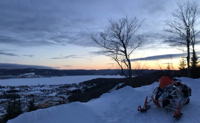 Photo of a snowmobile above Pointe-a-la-Croix at sunset