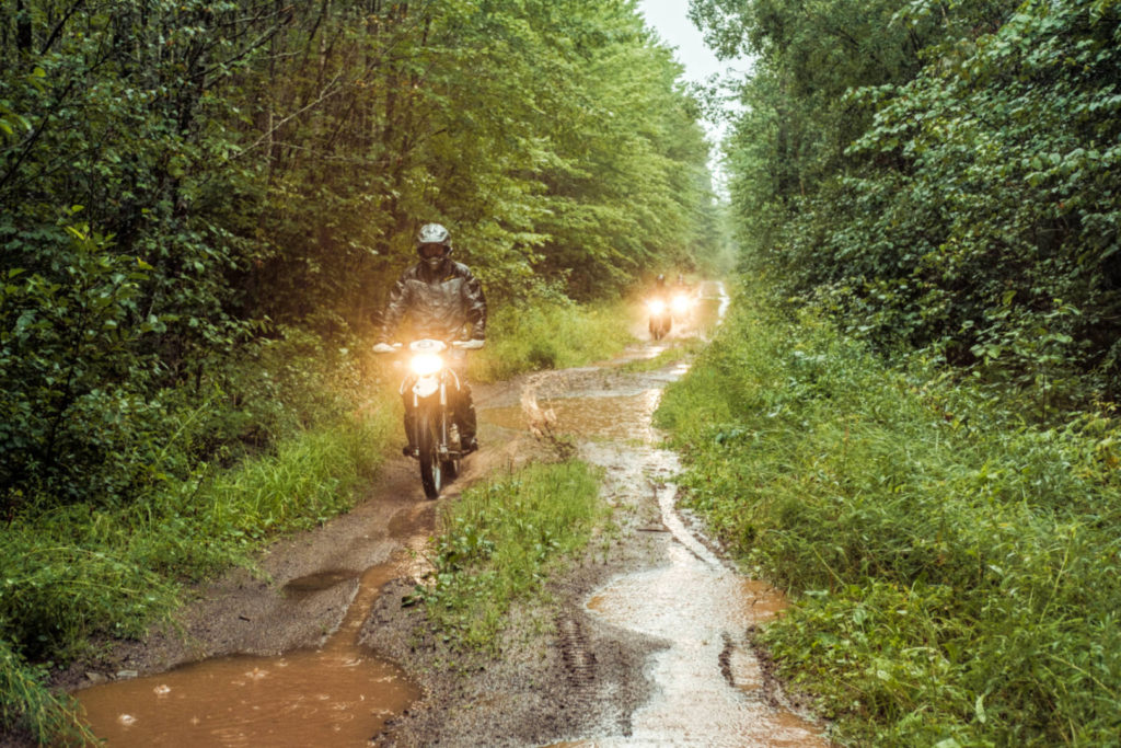 a photo of motorcycles riding in mud and rain at the Fundy Adventure Rally