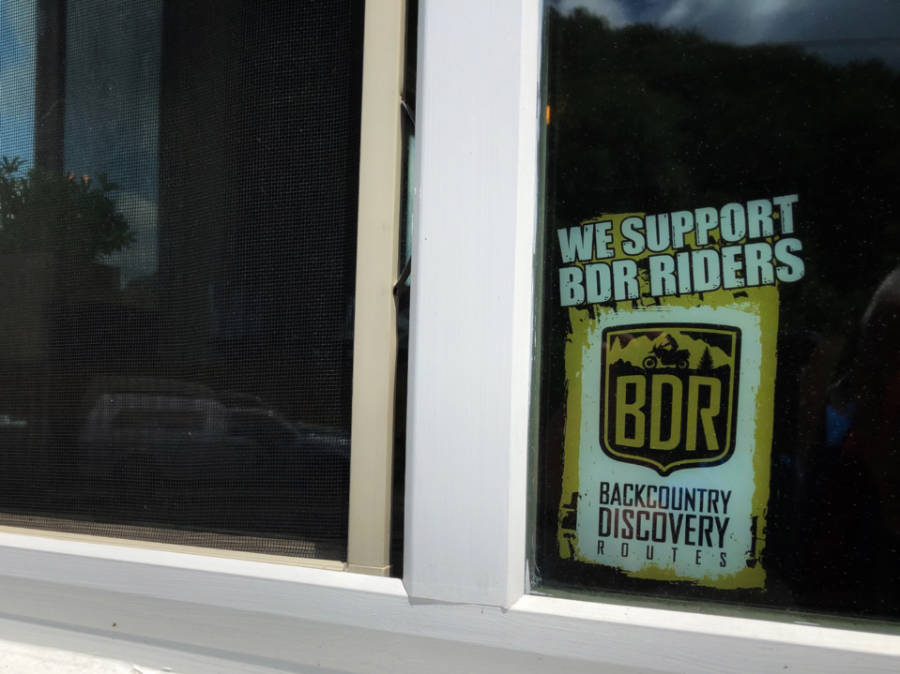 a sticker supporting the Back Country Discovery Routes on a restaurant window
