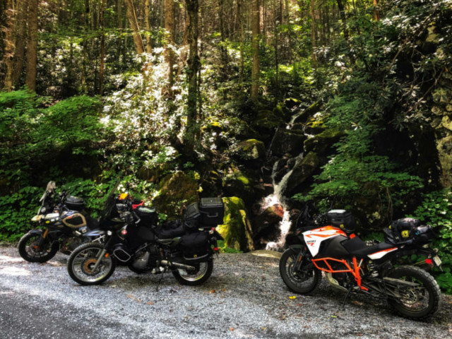 a photo of 3 adventure motorcycles in front of a waterfall on the MABDR