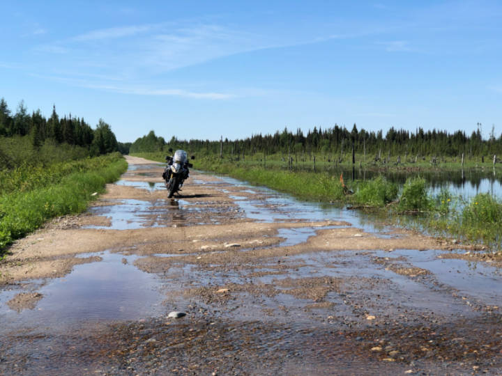 a photo of water covering a gravel road