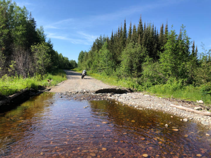 a photo of water covering a gravel road