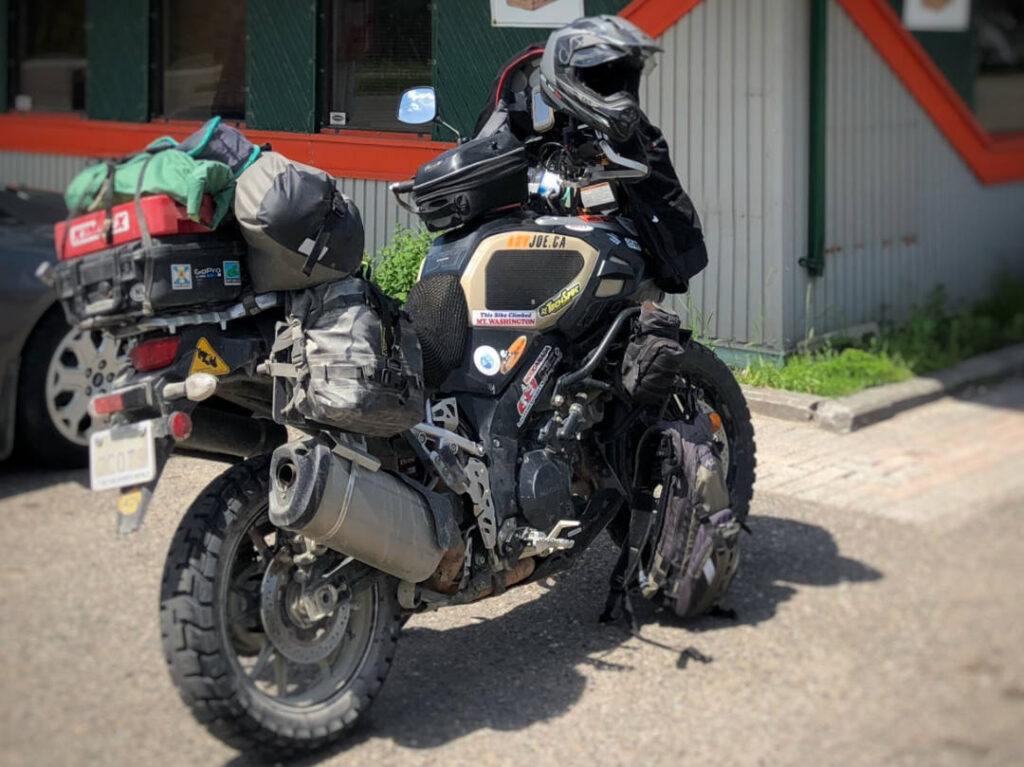 A photo of a Suzuki VStrom motorcycle packed with camping gear