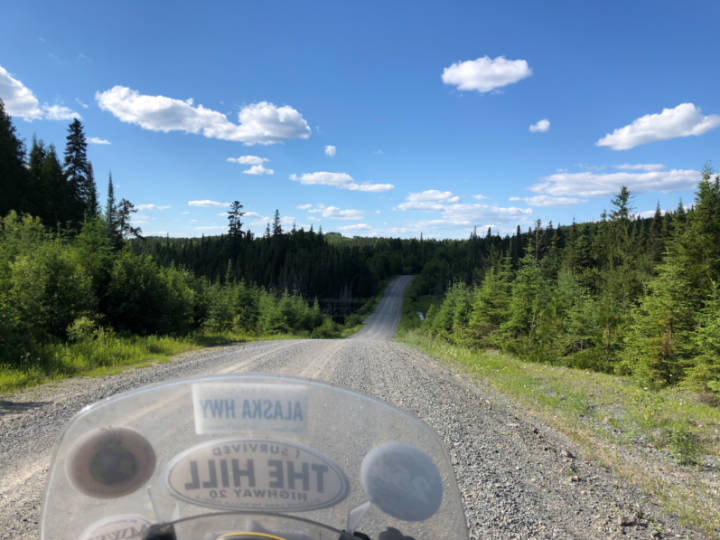 a photo of a gravel forest logging road